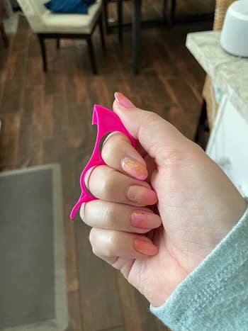 a reviewer holding the pink peeler