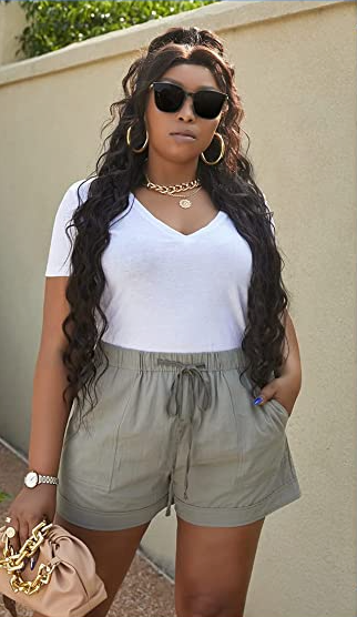 A model posing in the green shorts