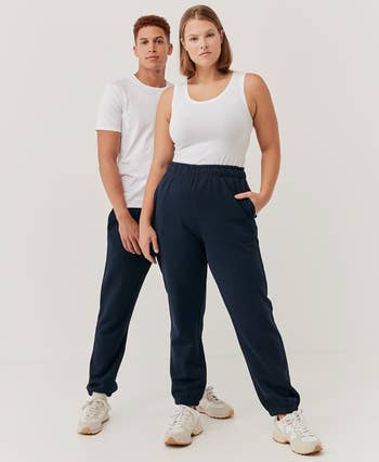 two models wearing the gender neutral sweatpant in maritime navy