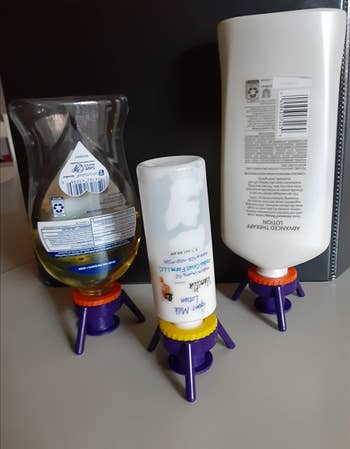 Several shampoo and hair products balanced on the tripods 