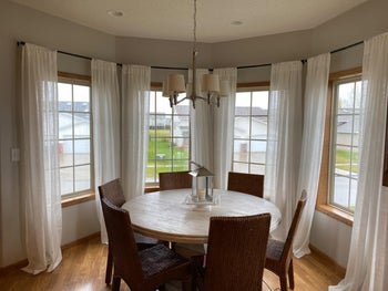 a reviewer's white linen curtains in a dining room