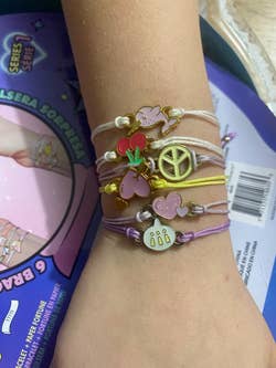 a stack of bracelets on a kids arm