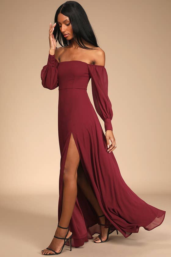 a model posing in the burgundy dress and off the shoulder sleeves