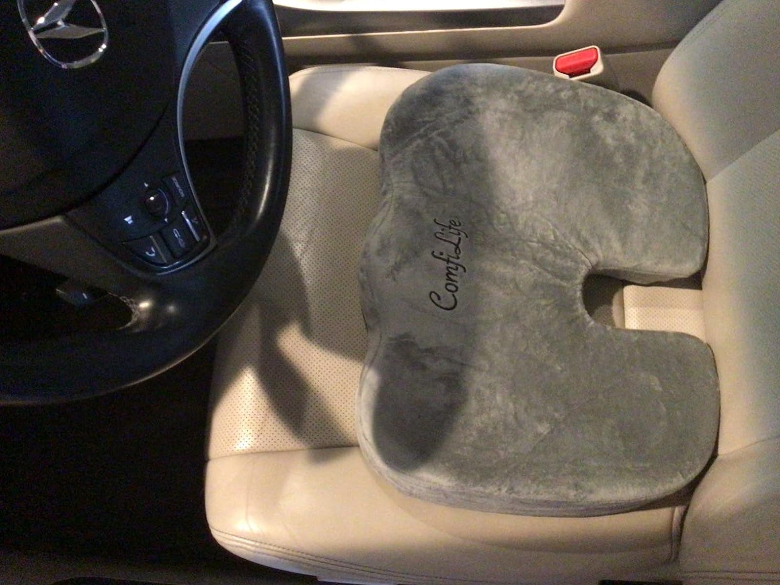 a reviewer photo of the seat cushion on a car driver seat 