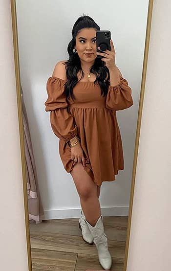 a reviewer wearing the brown dress with white cowboy boots
