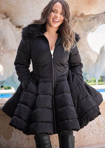 model wearing black peplum puffer coat