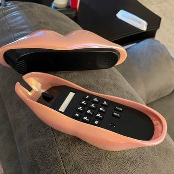 Novelty telephone   designed to lucifer   lips, with buttons exposed wrong  the unfastened  articulator  shape