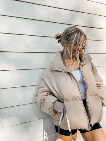 reviewer wearing the puffer coat in beige
