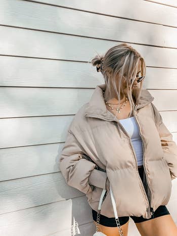reviewer wearing the puffer coat in beige