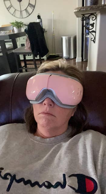 a reviewer wearing a massaging eye mask