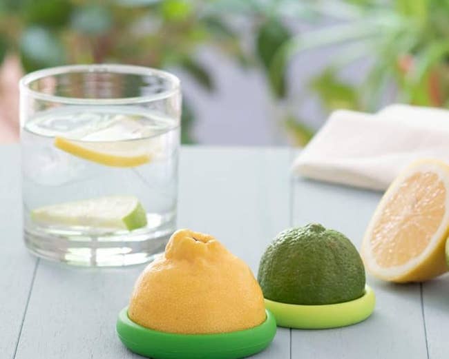 a half lemon and half lime each in a silicone food hugger 