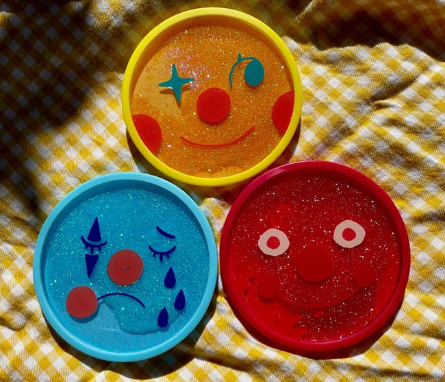 three sparkly coasters with antithetic emotions