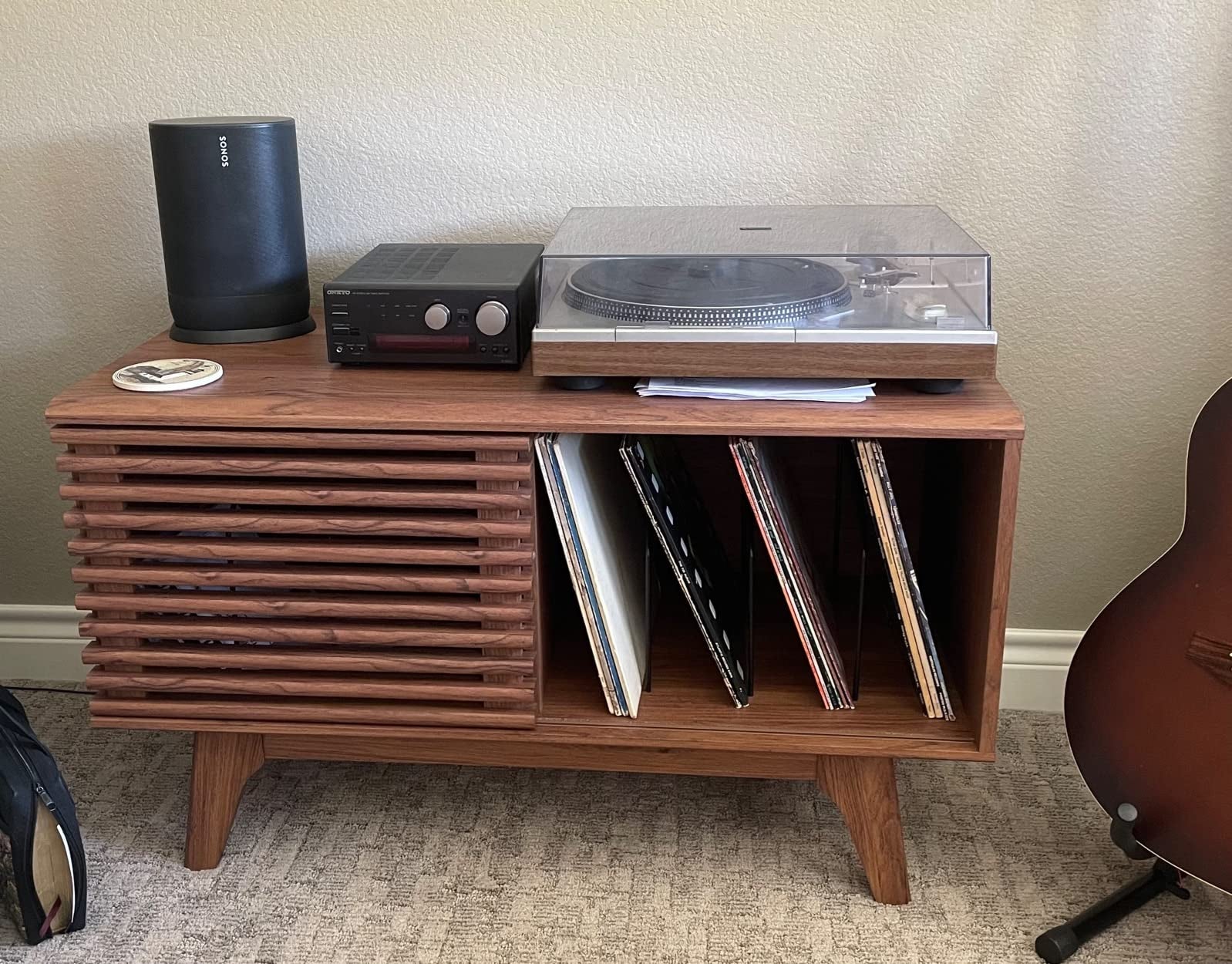 Reviewer image of wide brown wooden record player stand with sliding door and record player on top