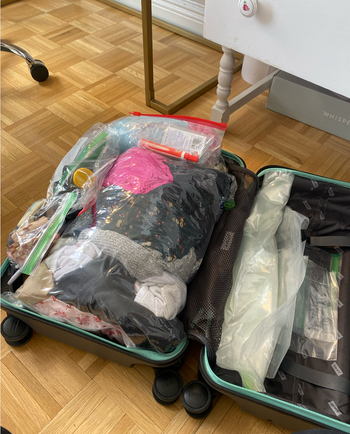 The clothes packed neatly in compression bags to fit in the suitcase 
