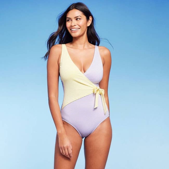 model in lavender and yellow seersucker v-neck swimsuit with side tie