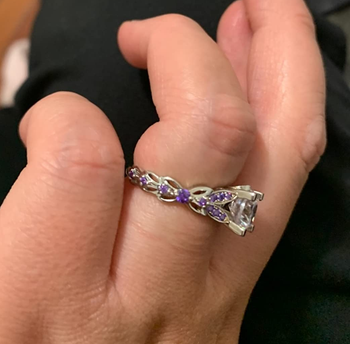 The same reviewer wearing the ring showing the purple stones