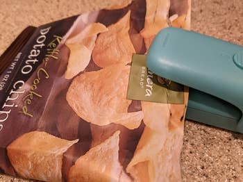 reviewer's blue bag sealer on a bag of open Panera potato chips