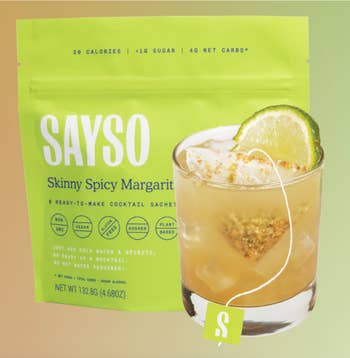 Sayso Skinny Spicy Margarita cocktail premix  container  with a solid  of margarita garnished with lime and rimmed with spice