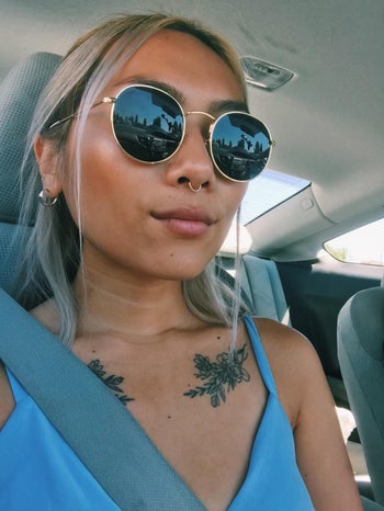 reviewer in gold frame sunnies
