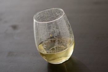 Clear stemless wine glass etched with white map of NYC 