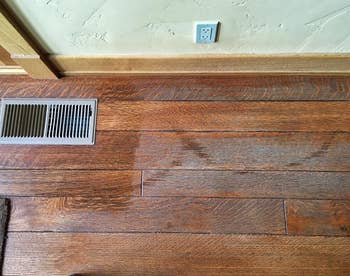 reviewer before photo of a dull, worn wood floor