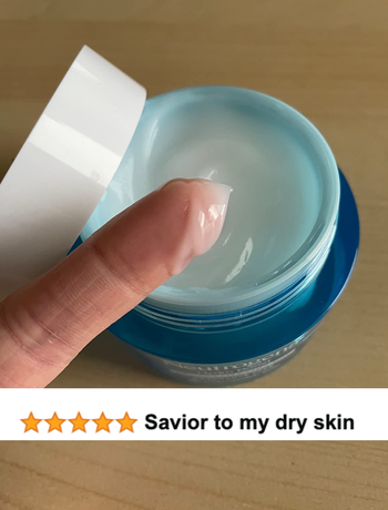 reviewer image of moisturizer on their finger with a review on top that says 