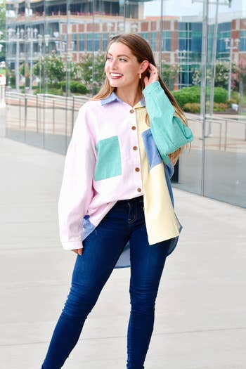 model in the pink yellow blue and green oversized button down worn buttoned