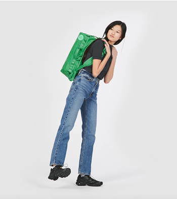 model carrying green go-bag on her back
