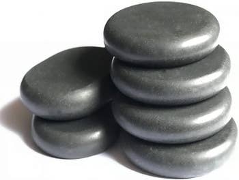 six of the black hot stones stacked in two stacks
