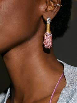 model in rose bottle earrings