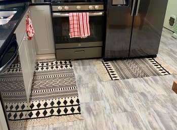 Reviewer image of both the black and white rugs in the kitchen