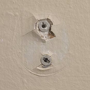 after photo of screws in the wall and you can see where the disc has expanded to plug some of the gaps