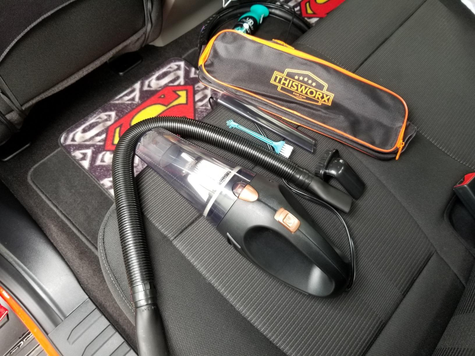 a reviewer photo of the portable vacuum, travel case, and included detail attachments 