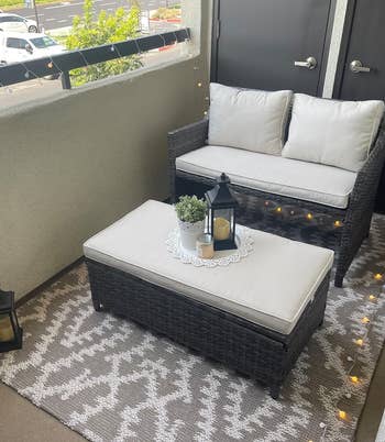 Outdoor patio furniture setup featuring a sofa, cushioned chairs, and a coffee table with decorative items. Perfect for balcony shopping ideas