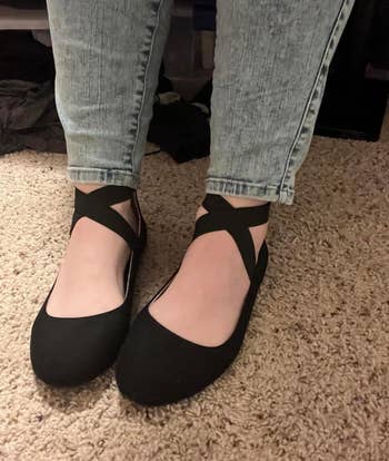 reviewer wearing black strap flats