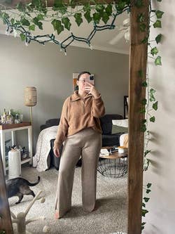 reviewer wearing the brown pants