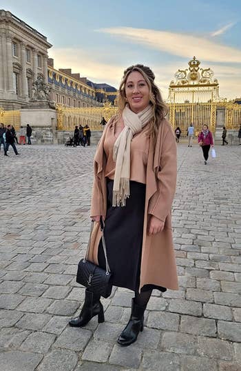 reviewer wearing the black skirt in front of the gates of Versailles