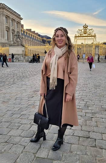 reviewer wearing the black skirt in front of the gates of Versailles