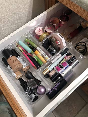 reviewer photo showing drawer organizers with makeup products