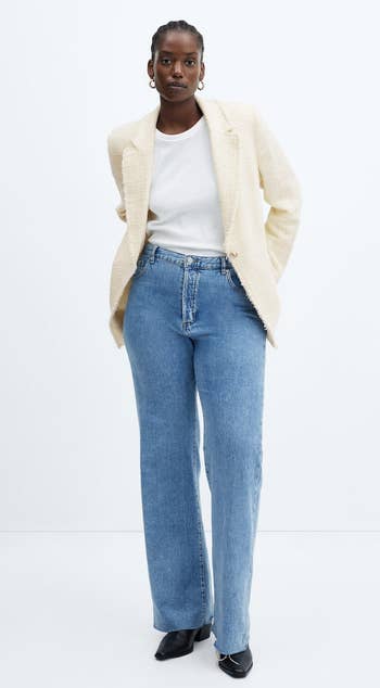 model in the ivory blazer with blue jeans and a white tee