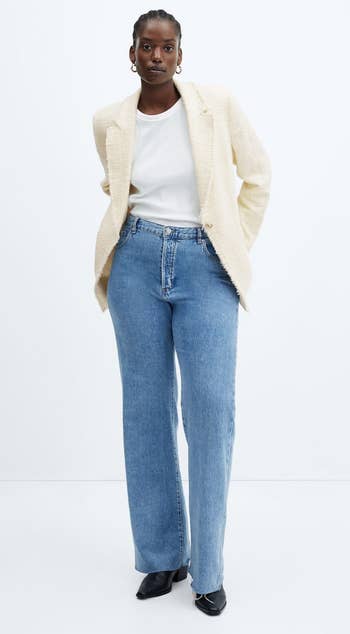 model in the ivory blazer with blue jeans and a white tee