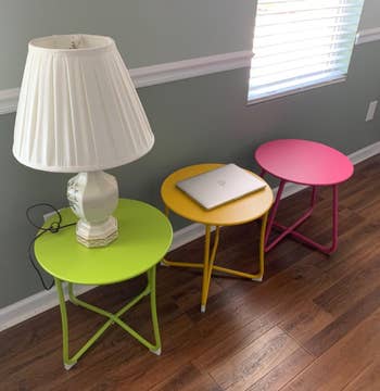 Image of three outdoor side tables in green, yellow, and pink