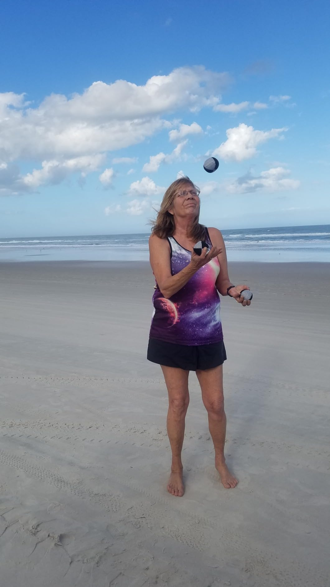 A reviewer juggling connected  a beach