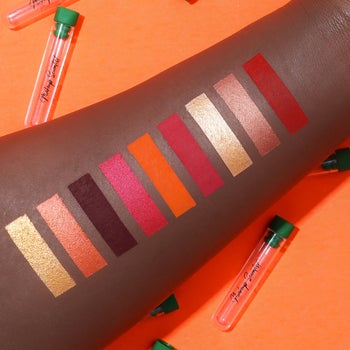 a model showing swatches of the colors in the palette on their arm