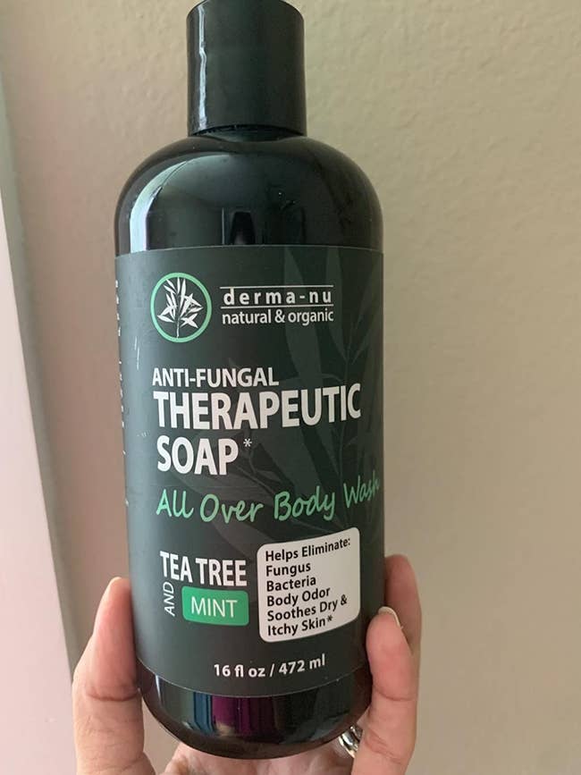 image of reviewer holding up the bottle of body wash