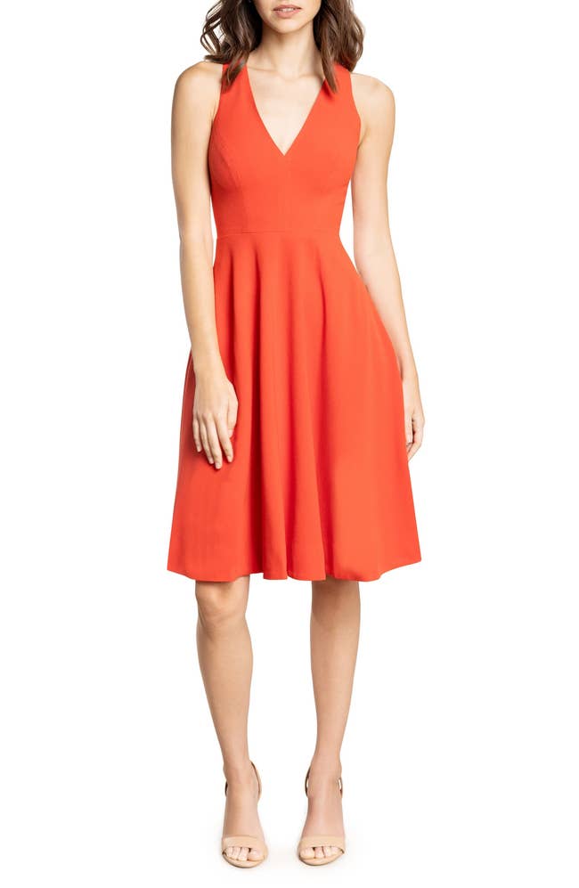 model in v neck midi dress in bright orange