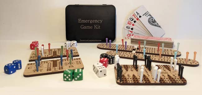 Emergency Game Kit with deck of cards, dice, and wooden peg boards for various games
