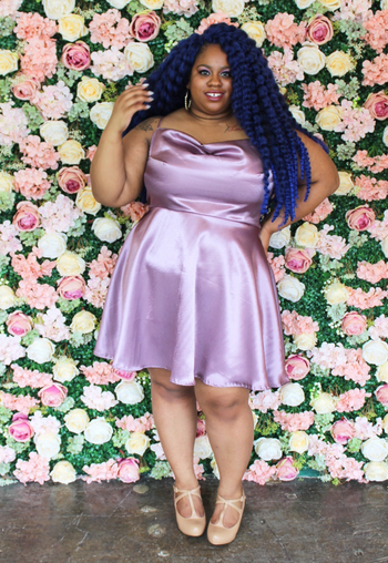 model in the short lilac satin dress