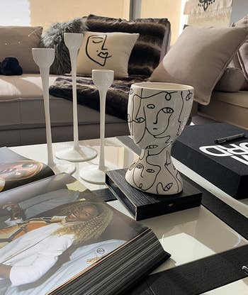 reviewer photo of the head-shaped vase on a coffee table