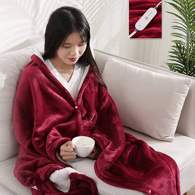 a model wearing the rose red blanket around their shoulders
